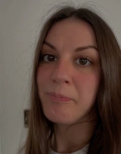 A Close Up Of A Woman 'S Face With A White Shirt On GIF