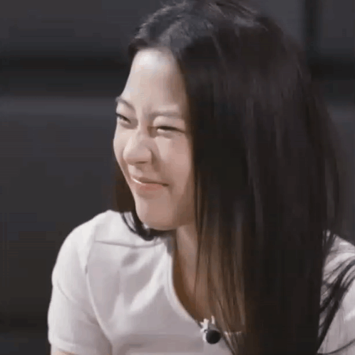 A Close Up Of A Woman 'S Face With A White Shirt On GIF