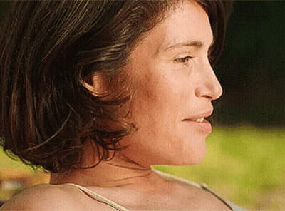 A Close Up Of A Woman 'S Face With A White Shirt On GIF