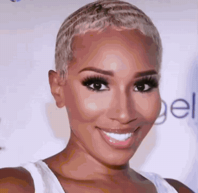 A Close Up Of A Woman 'S Face With A White Tank Top On GIF