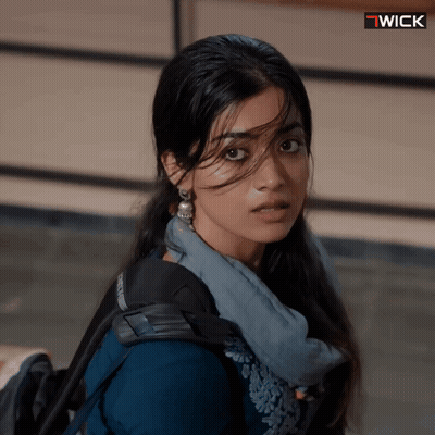 A Close Up Of A Woman 'S Face With A Wick Logo Above Her GIF