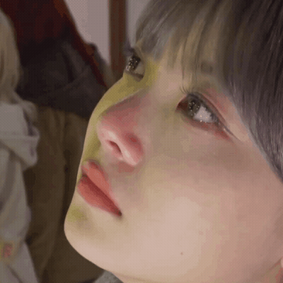 A Close Up Of A Woman 'S Face With A Yellow Mask On Her Nose GIF