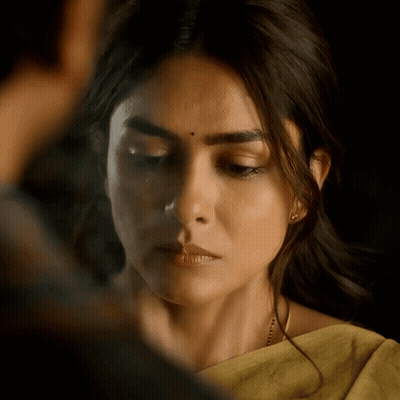 A Close Up Of A Woman 'S Face With A Yellow Saree On GIF