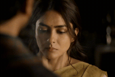 A Close Up Of A Woman 'S Face With A Yellow Saree GIF