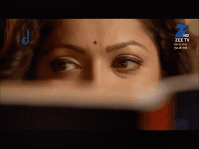A Close Up Of A Woman 'S Face With A Zee Tv Logo On The Bottom GIF