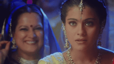 A Close Up Of A Woman 'S Face With Another Woman Behind Her Smiling GIF