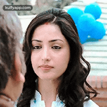 A Close Up Of A Woman 'S Face With Balloons In The Background GIF