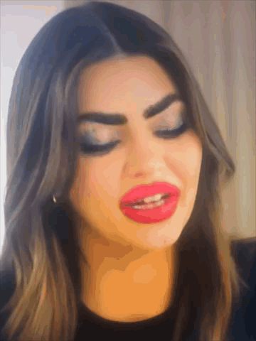 A Close Up Of A Woman 'S Face With Big Red Lips GIF