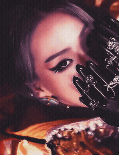 A Close Up Of A Woman 'S Face With Black Gloves On GIF