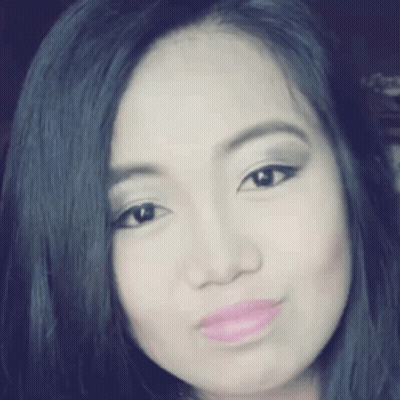 A Close Up Of A Woman 'S Face With Black Hair And Pink Lips . GIF