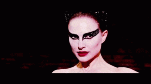 A Close Up Of A Woman 'S Face With Black Makeup On . GIF