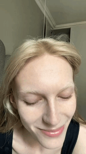 A Close Up Of A Woman 'S Face With Blonde Hair GIF