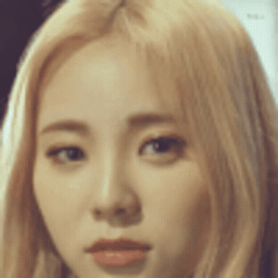 A Close Up Of A Woman 'S Face With Blonde Hair . GIF