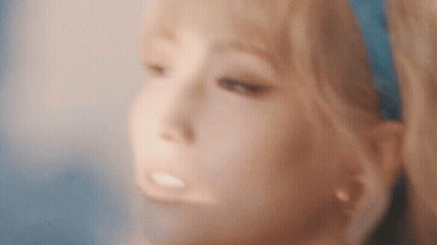 A Close Up Of A Woman 'S Face With Blonde Hair And A Blue Headband . GIF
