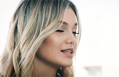 A Close Up Of A Woman 'S Face With Blonde Hair And A Nose Ring . GIF