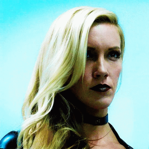 A Close Up Of A Woman 'S Face With Blonde Hair And Black Lips GIF