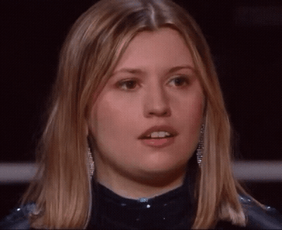 A Close Up Of A Woman 'S Face With Blonde Hair GIF