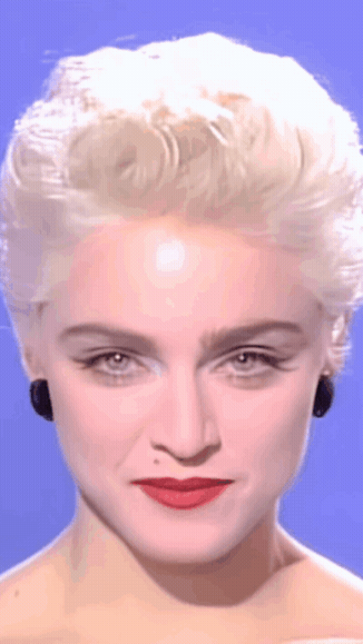 A Close Up Of A Woman 'S Face With Blonde Hair GIF