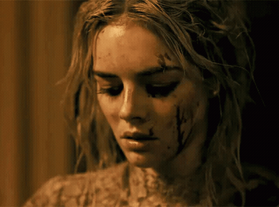 A Close Up Of A Woman 'S Face With Blood On Her Face GIF