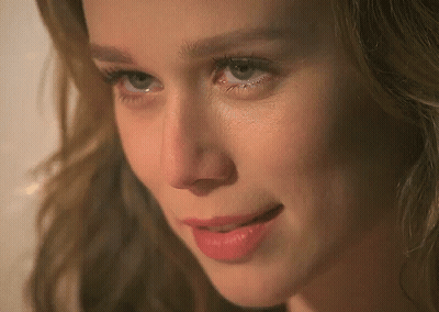A Close Up Of A Woman 'S Face With Blue Eyes And Red Lips GIF