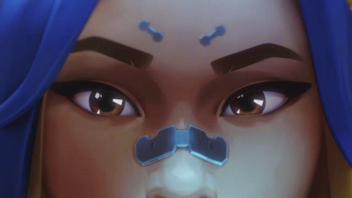 A Close Up Of A Woman 'S Face With Blue Hair And A Nose Ring GIF