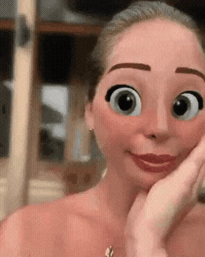 A Close Up Of A Woman 'S Face With Cartoon Eyes GIF