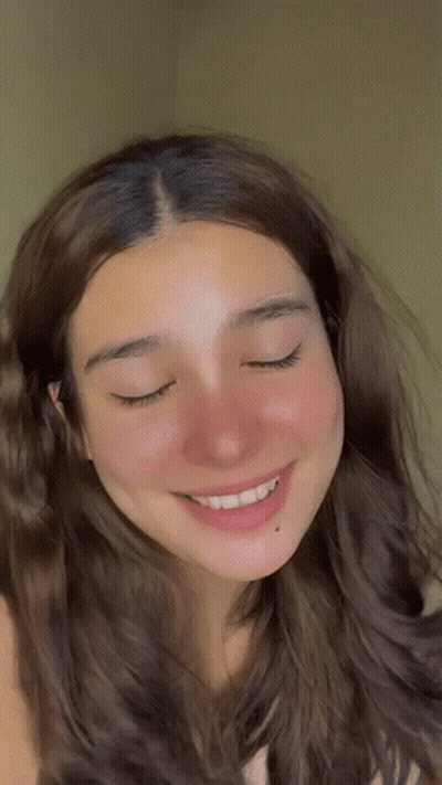 A Close Up Of A Woman 'S Face With Closed Eyes GIF