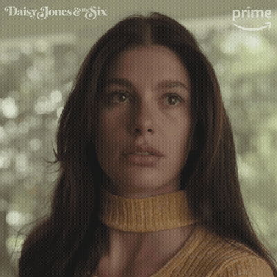 A Close Up Of A Woman 'S Face With Daisy Jones & The Six Written On The Bottom GIF