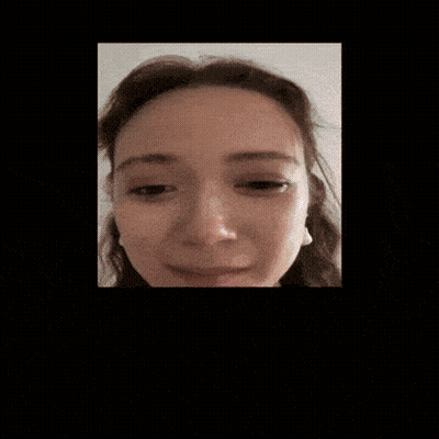A Close Up Of A Woman 'S Face With Earrings GIF