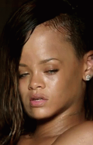 A Close Up Of A Woman 'S Face With Earrings On GIF