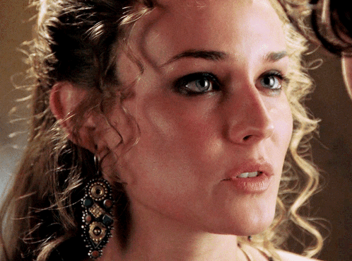 A Close Up Of A Woman 'S Face With Earrings On Her Ear GIF