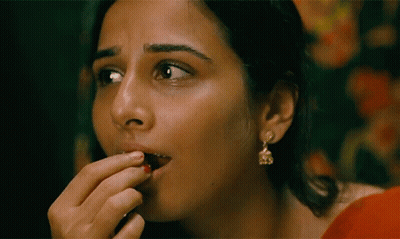 A Close Up Of A Woman 'S Face With Earrings On GIF