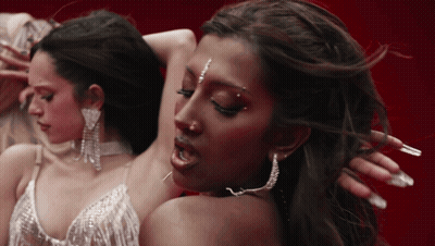 A Close Up Of A Woman 'S Face With Earrings On GIF