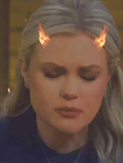 A Close Up Of A Woman 'S Face With Fire Coming Out Of Her Hair GIF