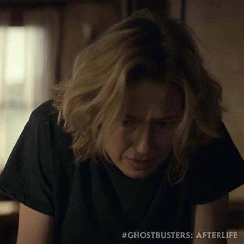 A Close Up Of A Woman 'S Face With #Ghostbusters Afterlife On The Bottom GIF