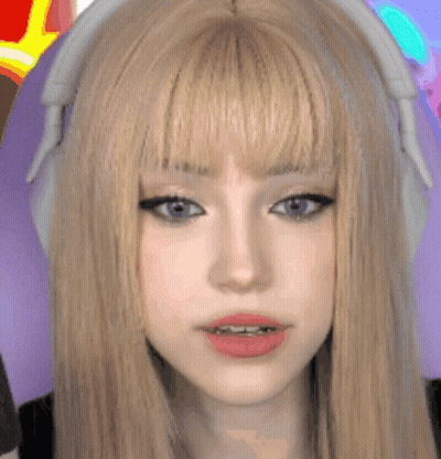 A Close Up Of A Woman 'S Face With Headphones On . GIF