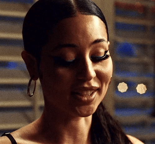 A Close Up Of A Woman 'S Face With Her Eyes Closed . GIF