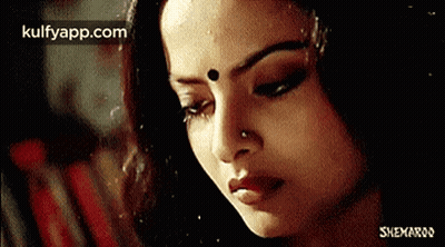 A Close Up Of A Woman 'S Face With Her Eyes Closed GIF