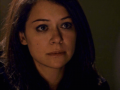 A Close Up Of A Woman 'S Face With Her Eyes Closed And Her Hair Blowing In The Wind . GIF