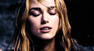 A Close Up Of A Woman 'S Face With Her Eyes Closed And Her Hair Blowing In The Wind GIF