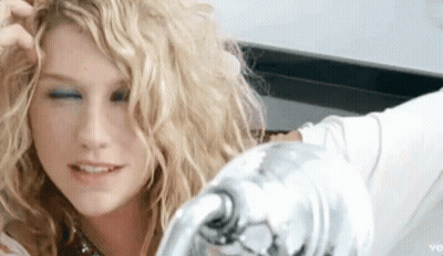 A Close Up Of A Woman 'S Face With Her Eyes Closed And Her Hair In Her Hand . GIF