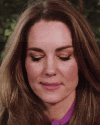 A Close Up Of A Woman 'S Face With Her Eyes Closed And Her Mouth Open . GIF