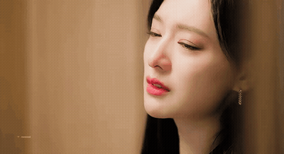 A Close Up Of A Woman 'S Face With Her Eyes Closed And Her Mouth Open . GIF