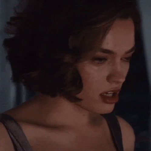 A Close Up Of A Woman 'S Face With Her Eyes Closed And Her Mouth Open . GIF
