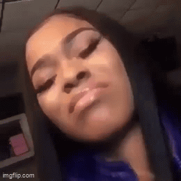 A Close Up Of A Woman 'S Face With Her Eyes Closed And Her Mouth Open . GIF