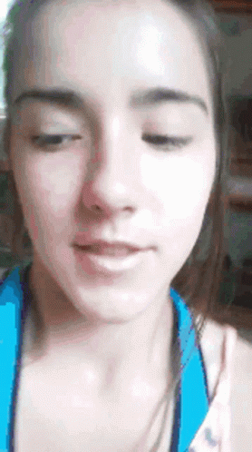 A Close Up Of A Woman 'S Face With Her Eyes Closed And Her Mouth Open GIF