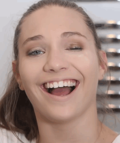 A Close Up Of A Woman 'S Face With Her Eyes Closed And Her Mouth Open GIF