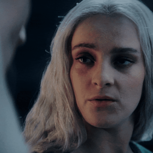A Close Up Of A Woman 'S Face With Her Eyes Closed GIF