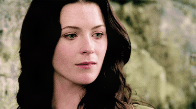 A Close Up Of A Woman 'S Face With Her Eyes Closed GIF