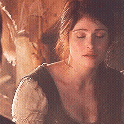 A Close Up Of A Woman 'S Face With Her Eyes Closed In A Dark Room . GIF